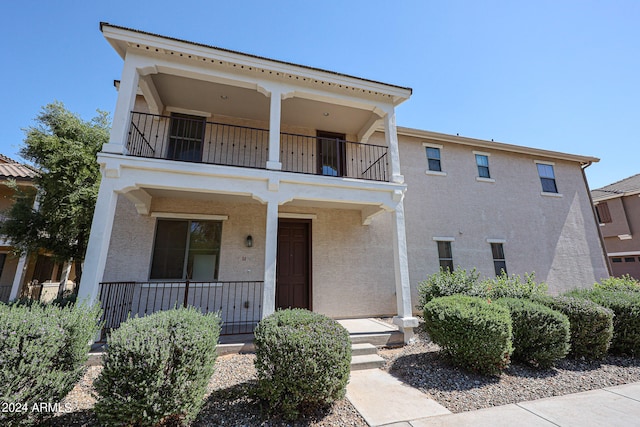 view of front of property with a balcony and covered porch