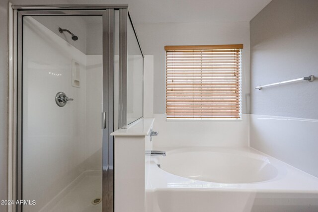 bathroom featuring separate shower and tub