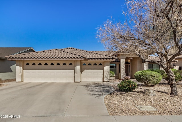 view of front of house featuring driveway, an attached garage, and stucco siding