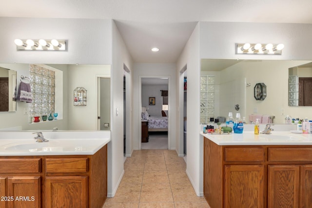 ensuite bathroom with a sink, two vanities, connected bathroom, and tile patterned floors