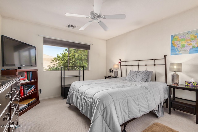 carpeted bedroom with baseboards, visible vents, and a ceiling fan