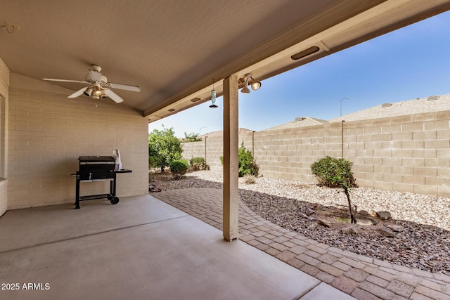 view of patio with ceiling fan, fence, and grilling area