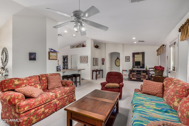 carpeted living room featuring arched walkways, ceiling fan, recessed lighting, visible vents, and vaulted ceiling