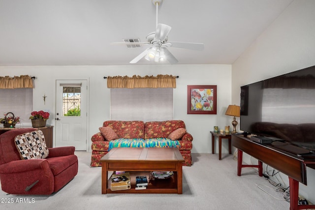 living room featuring carpet floors, visible vents, and a ceiling fan