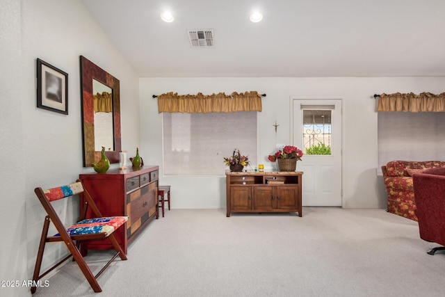 living area with light colored carpet, visible vents, and recessed lighting