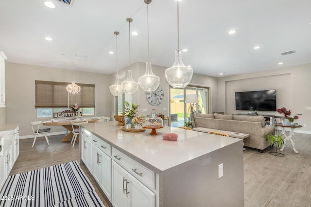 8772 W Brooklite Ln, Peoria, AZ 85383 - kitchen featuring a kitchen island, light wood-type flooring, white cabinetry, light countertops, and recessed lighting