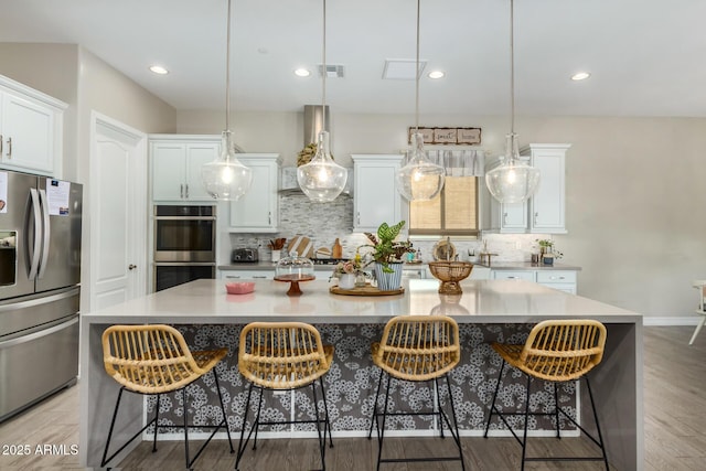 8772 W Brooklite Ln, Peoria, AZ 85383 - kitchen with stainless steel appliances, tasteful backsplash, white cabinets, a large island, and recessed lighting