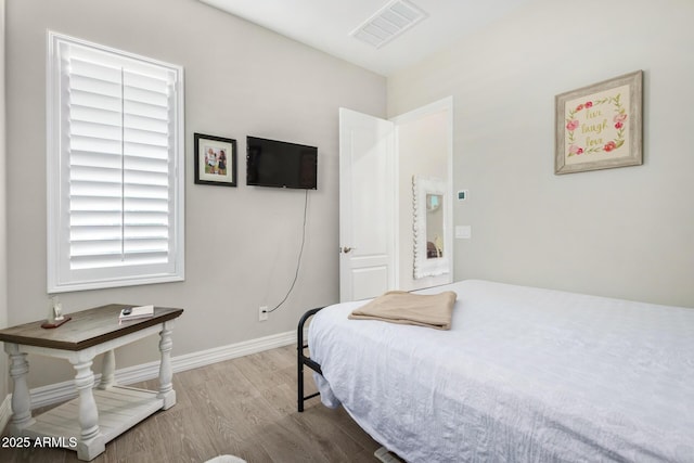 8772 W Brooklite Ln, Peoria, AZ 85383 - bedroom featuring wood finished floors and baseboards