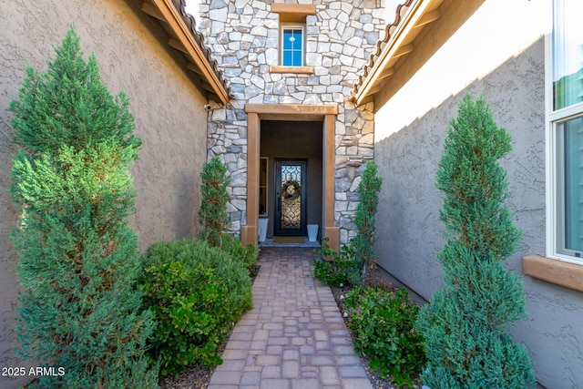 8772 W Brooklite Ln, Peoria, AZ 85383 - doorway to property with stone siding and stucco siding