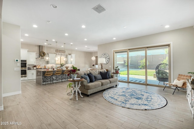 8772 W Brooklite Ln, Peoria, AZ 85383 - living room with light wood-type flooring and recessed lighting
