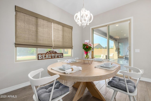 8772 W Brooklite Ln, Peoria, AZ 85383 - dining area with a chandelier, wood finished floors, and baseboards