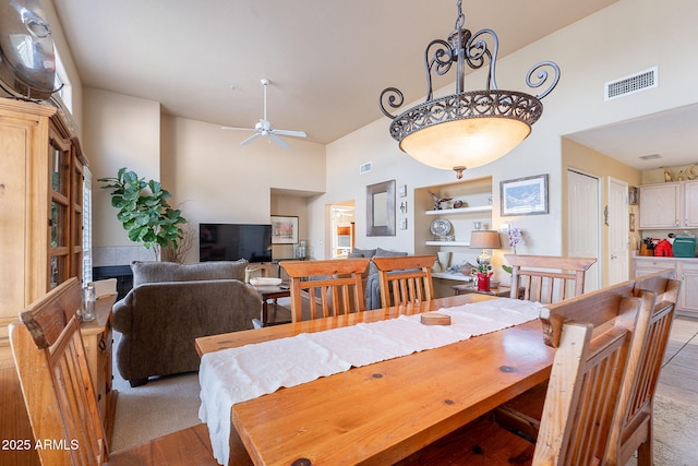 11260 N 92nd St Unit 2111, Scottsdale, AZ 85260 - dining area featuring a towering ceiling, ceiling fan, and light wood-style floors