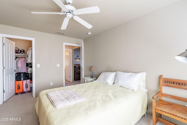 11260 N 92nd St Unit 2111, Scottsdale, AZ 85260 - bedroom featuring light colored carpet, a walk in closet, ceiling fan, and a closet