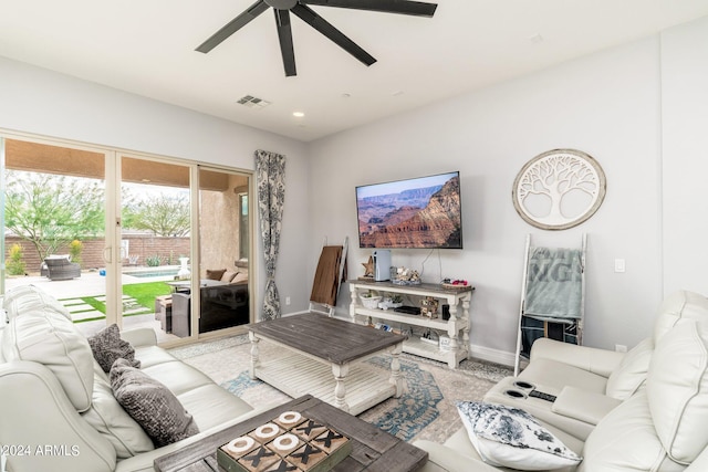 living room with light carpet and ceiling fan