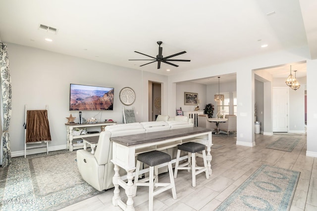 interior space with ceiling fan with notable chandelier