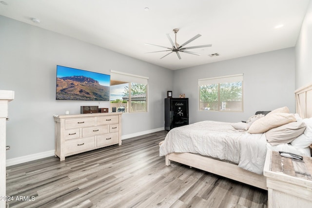 bedroom with ceiling fan and hardwood / wood-style flooring