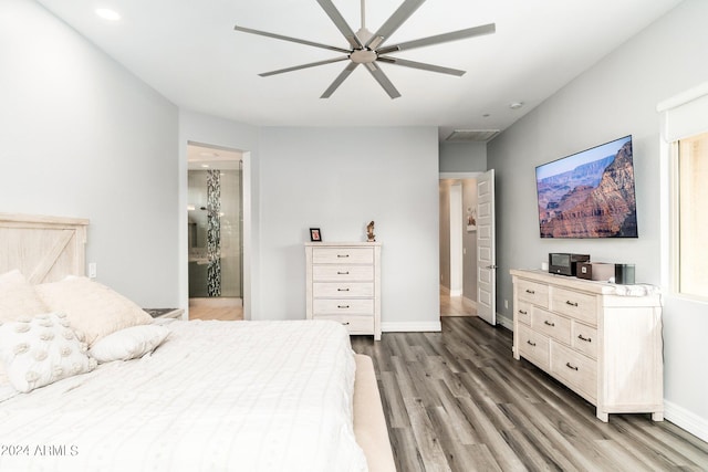 bedroom with ceiling fan, ensuite bathroom, and wood-type flooring