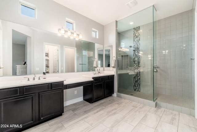 bathroom with tile flooring, double sink, an enclosed shower, and oversized vanity