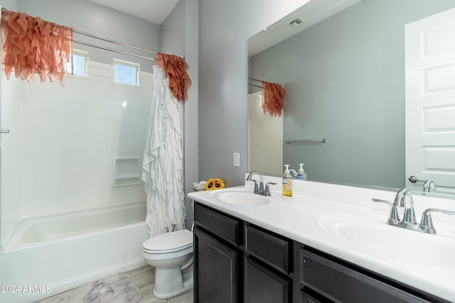 full bathroom with shower / tub combo, tile floors, toilet, and dual bowl vanity