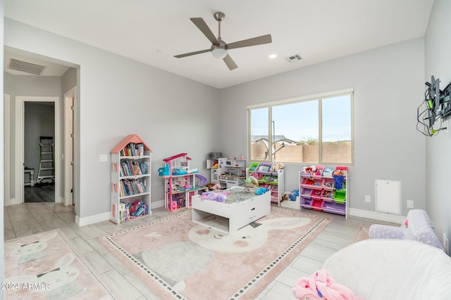 rec room with light hardwood / wood-style floors and ceiling fan