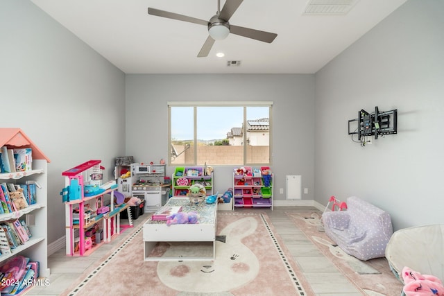 rec room with ceiling fan and light hardwood / wood-style flooring