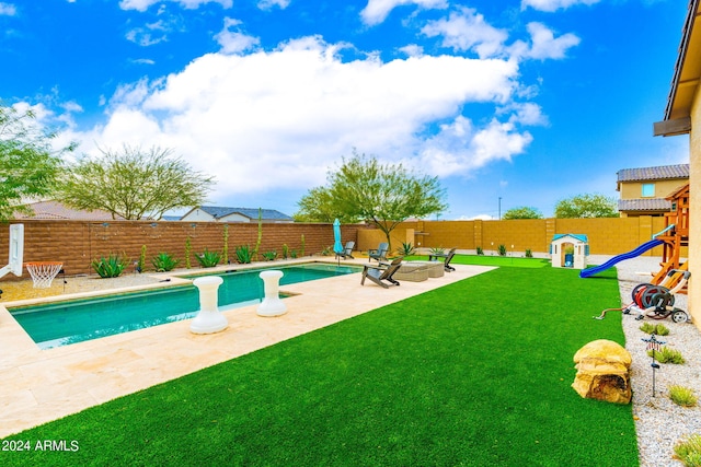 view of pool featuring a yard and a patio