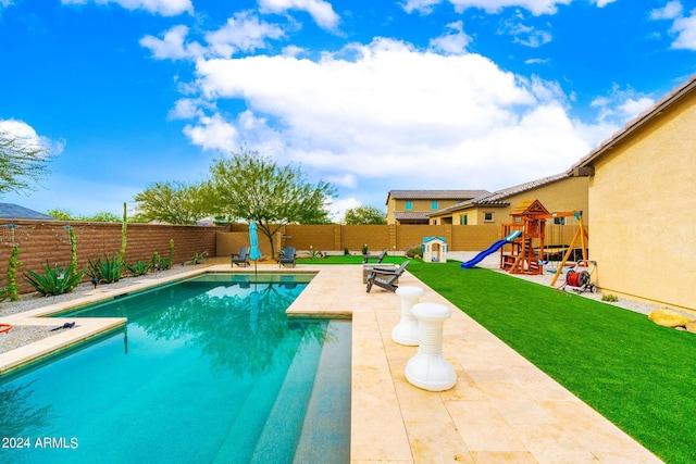 view of swimming pool with a patio, a playground, and a yard