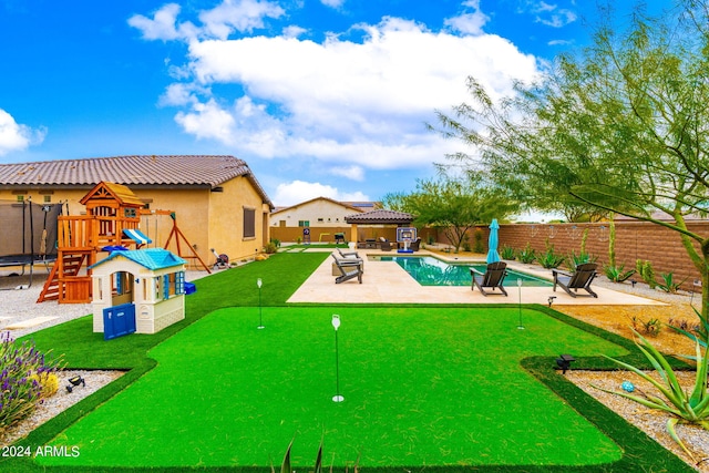 exterior space with a playground, a fenced in pool, and a patio