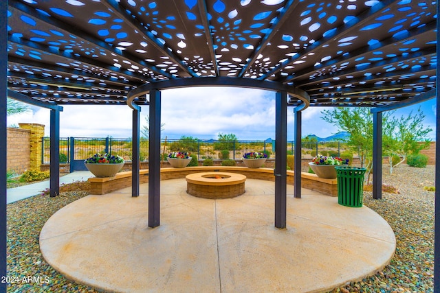 view of patio featuring a fire pit and a pergola