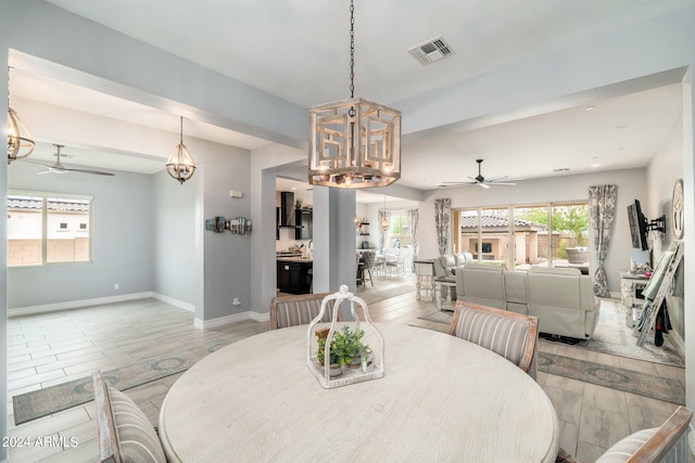 dining room with light tile flooring and ceiling fan with notable chandelier