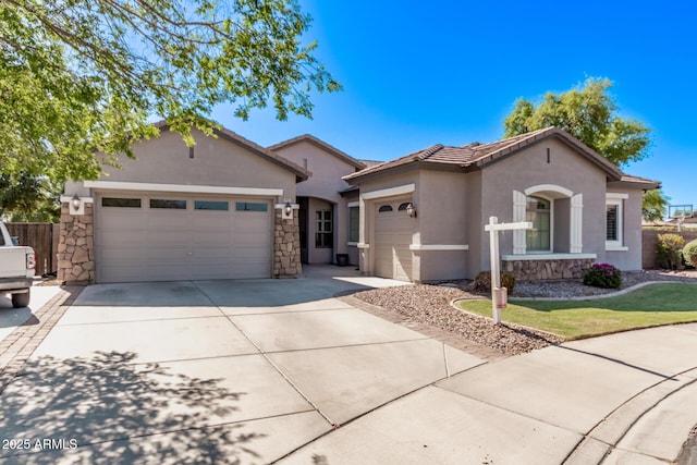 view of front facade featuring an attached garage, stucco siding, concrete driveway, stone siding, and a tile roof