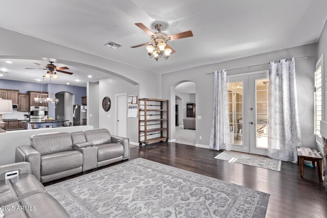 living area with a ceiling fan, arched walkways, dark wood finished floors, and recessed lighting