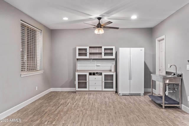 unfurnished living room with ceiling fan, wood finished floors, baseboards, and recessed lighting