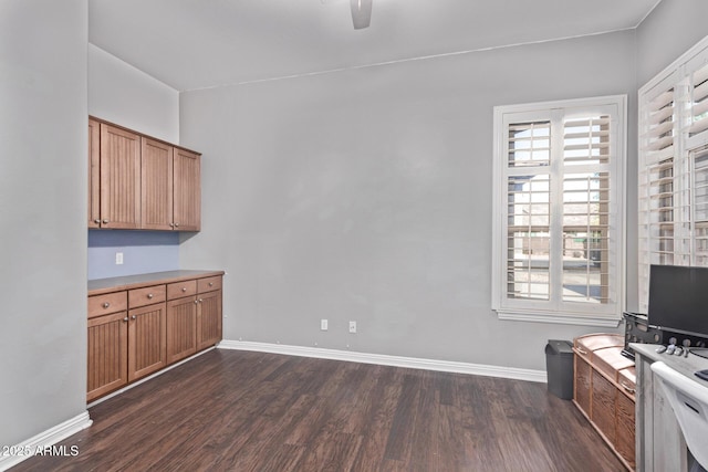 kitchen featuring dark wood-style floors, healthy amount of natural light, and brown cabinetry
