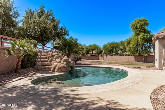 view of swimming pool with a fenced backyard and a patio area