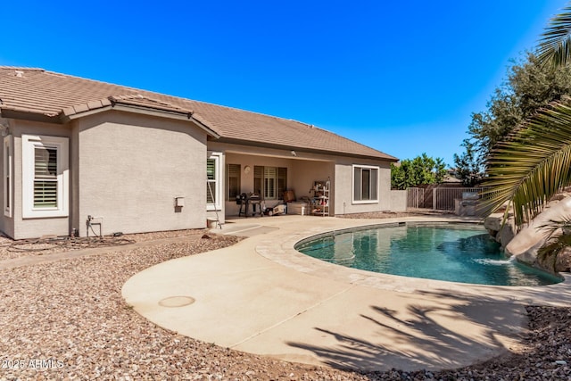view of swimming pool featuring a patio and a fenced backyard