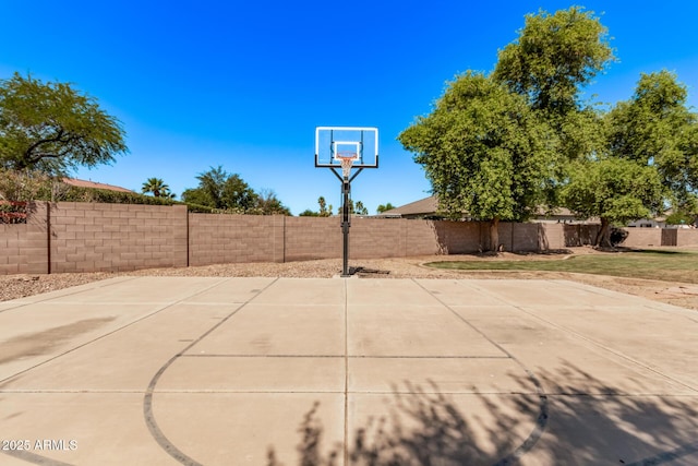 view of basketball court featuring basketball court and a fenced backyard