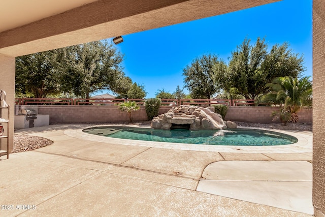 view of swimming pool featuring a fenced backyard and a patio area