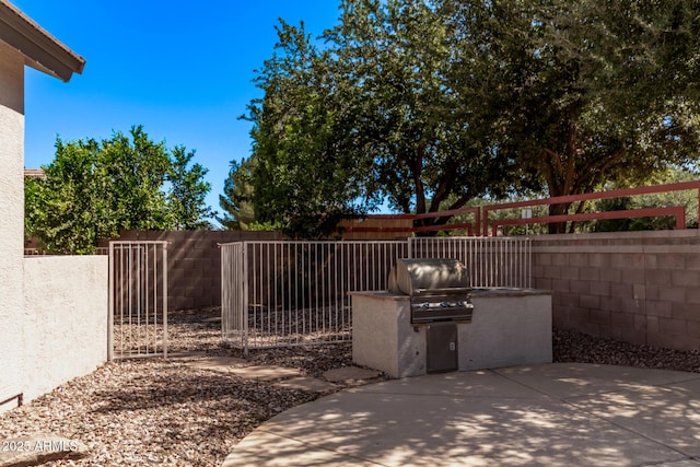 view of patio / terrace featuring an outdoor kitchen and fence