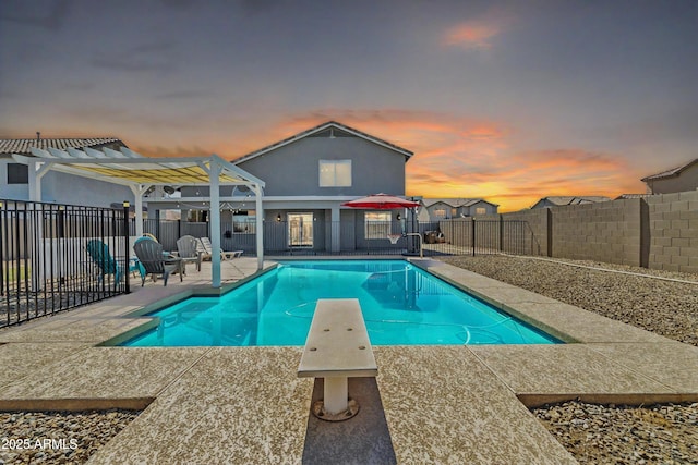 view of pool with a fenced in pool, a fenced backyard, a patio area, a diving board, and a pergola