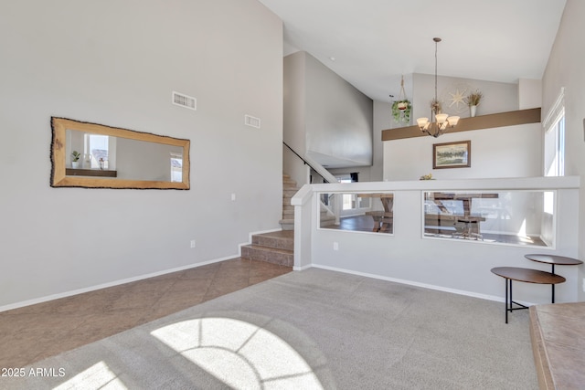 living room featuring stairs, high vaulted ceiling, a chandelier, and visible vents