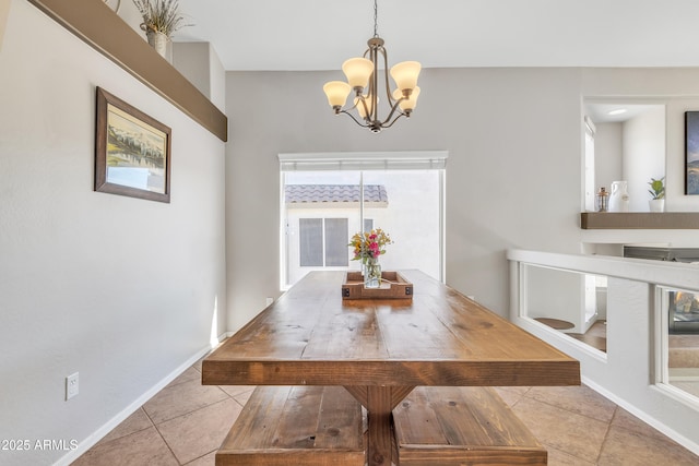 dining area featuring tile patterned flooring, baseboards, and a notable chandelier