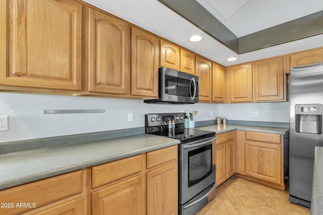 kitchen with appliances with stainless steel finishes, recessed lighting, and light tile patterned flooring