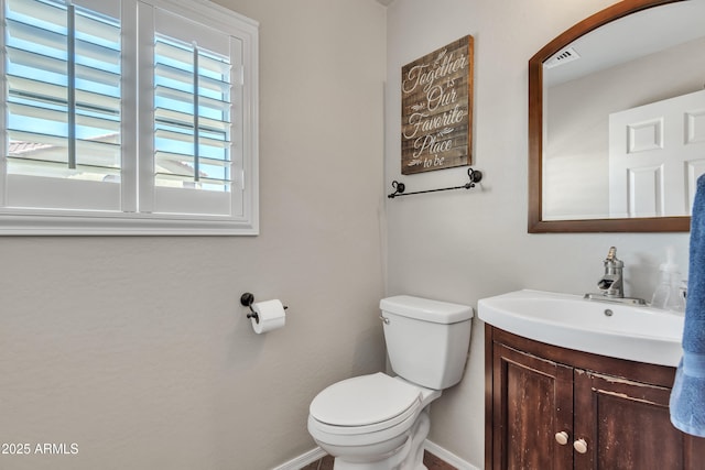 bathroom featuring toilet, baseboards, visible vents, and vanity