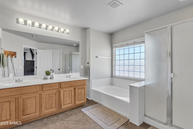 full bathroom featuring a garden tub, a sink, visible vents, and a shower stall