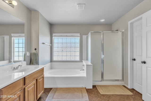 full bathroom with vanity, tile patterned flooring, visible vents, and a shower stall