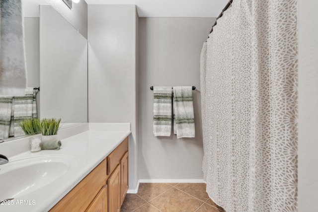 full bath featuring tile patterned flooring, vanity, and baseboards