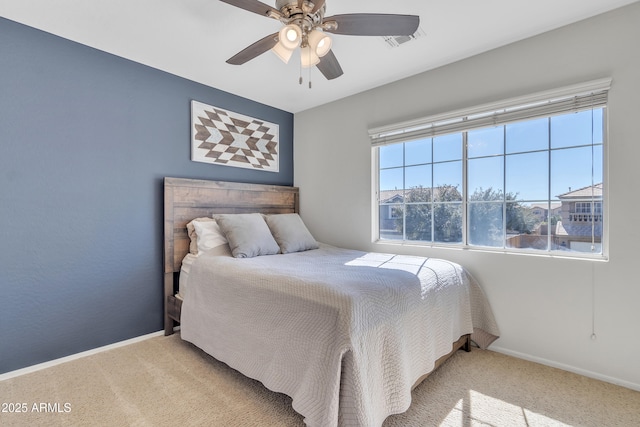 carpeted bedroom featuring visible vents, a ceiling fan, and baseboards