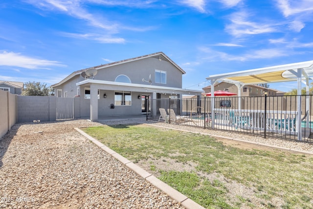 back of property featuring a fenced in pool, a patio, stucco siding, a pergola, and a fenced backyard