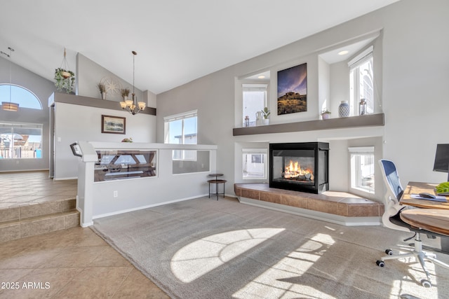 interior space featuring high vaulted ceiling, a chandelier, a healthy amount of sunlight, and a tiled fireplace